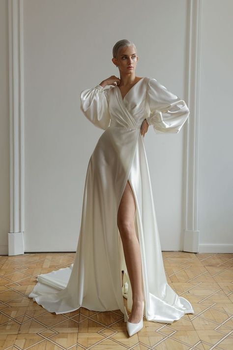 This beautiful A-line dress is made from ivory silk and features a slit up the skirt as well as a train.  The long puffy sleeves are made from a beautiful boho satin fabric. The dress is completed with a simple yet sexy silhouette. Wedding Dress Silk, Wedding Dress Minimalist, Wedding Dress Modest, Formal Wedding Dress, Wedding Dress Satin, Minimalist Wedding Dress, Silk Wedding Gown, Dress Minimalist, Modest Wedding Dress