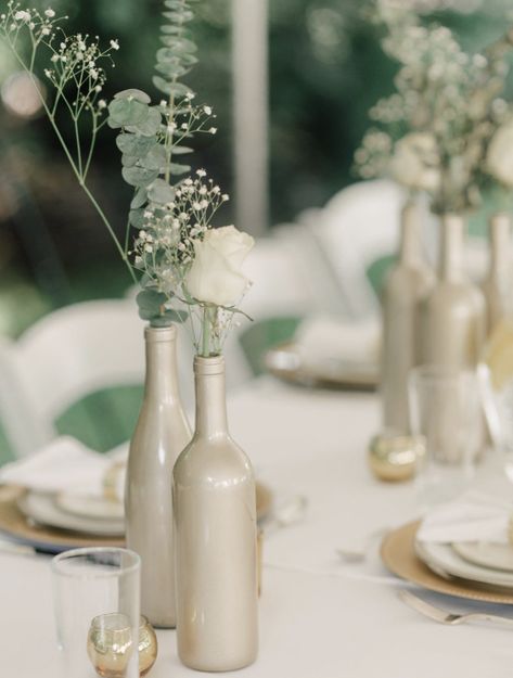 70+ DIY Wedding Decorations With Big-Budget Looks Wedding Bottle Decorations, Gold Wine Bottle Centerpiece, Bridal Shower Decor Table, Wine Bottle Centerpiece, Wine Bottle Wedding Centerpieces, Wine Bottle Centerpieces, Wedding Wine Bottles, Gold Wine, Bottle Centerpieces