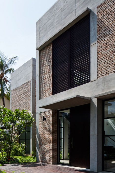 This house was stripped back to its concrete frame to create an open-plan villa featuring red brick walls, pivoting glass doors and leafy gardens. Brick And Concrete Facade, Vietnam House, Modern Brick House, Plan Villa, Concrete Houses, Concrete Facade, Concrete Architecture, Brick Exterior House, Brick Architecture