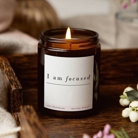 I Am Focused Affirmation Mindfulness Candle This stylish apothecary style jar candle is a thoughtful gift to remind someone special you have faith in them to do whatever they want, that they have 'got this' and are focused on reaching those stars. The embossed pure white label features the words, 'I am focused' with your optional personalised motivational affirmation message underneath along with your chosen scent and burn time. The 180ml jar candle is presented in an apothecary style jar with l Amber Candles, Affirmation Candles, Apothecary Candle, Self Care Gifts, Apothecary Style, Motivational Affirmations, Candles Ideas, Product Photoshoot, Honey Packaging