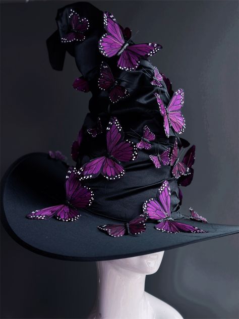 Transform your Halloween costume into a bewitching masterpiece with our black witch hat. This hat is adorned with beautiful purple butterflies that dance in the moonlight, adding an enchanting touch to your look. Whether you're brewing potions, casting spells, or just looking to turn heads, this hat will add an extra layer of magic to your ensemble. Age Group/Gender - Adult/Unisex Size/Type - One size fits all adults Hat Base Color - Black Hat Material - Fabric Witch Hat Alternative, Unique Witch Hat, Witch Costumes Purple, Purple Hair Witch Costume, Butterfly Witch Costume, Cool Witch Hats, Custom Witch Hat, Decorated Witches Hats, Which Halloween Costumes