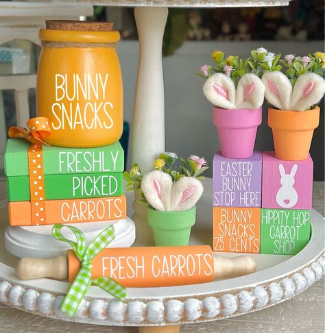 Easter Decor & Easter Tiered Tray Decor. Choose from our sweet Easter Mini Wood Book Stack, Easter Rolling Pin, set of 4 Easter stacking blocks, mini flower arrangement pots with Easter Bunny ears, or a bunny snack jar.... or choose them all for your Easter decor!  We offer over 900 other holiday and seasonal designs in our shop. https://www.etsy.com/shop/SweetBeanFarmhouse PLEASE READ DESCRIPTION, PROCESSING TIMES & ESTIMATED SHIPPING DATES IN ITS ENTIRETY. ❤ SIZE: WE ARE NOT RESPONSIBLE FOR FA Kitchenaid Decor, Carrot Snacks, Easter Book, Snack Jar, Easter Food Crafts, Bunny Decorations, Mini Rolling Pin, Easter Tiered Tray, Faux Books