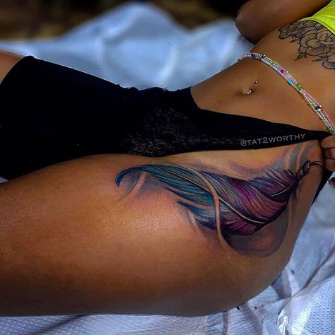 These tattoo ideas for black women are absolutely amazing. If you’re looking for tattoo inspiration, I hope you’ll find the perfect tattoo. This is a beautiful side body tattoo of a colorful feather. If you're looking for colored tattoo ideas for black women, this is great inspiration. Tattoo Ideas For Dark Skin, 22 Tattoo Ideas, Side Thigh Tattoos Women, Body Tattoo Ideas, Side Body Tattoo, Feather Tattoo Colour, Dark Skin Tattoo, Side Tattoos Women, 22 Tattoo