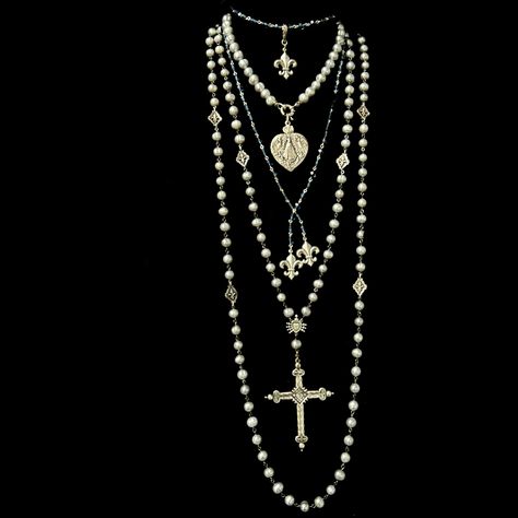 The Moonglow Sacred Heart Cross Rosary Necklace is designed as a true five decade rosary. It is 30" inches long and comes with a 4" complimentary extender that allows the necklace to be double. It features 9mm Silver Freshwater Pearls, mini Fleur de Lis and a reproduction French Sacred Heart Cross. The cross is two sided with the Sacred Heart on one side and a Lily at the center of the reverse. Length: 30" Gemstones: Silver Fresh Water Pearls Metal: Sterling Silver Clad Bronze Long Layered Pearl Necklace, Freshwater Pearls Jewelry, Gothic Wedding Jewelry, Long Cross Necklace, Silver Long Necklace, Multiple Necklaces, Pearl Chains, Long Pearl Necklace, Pendant Necklace Long