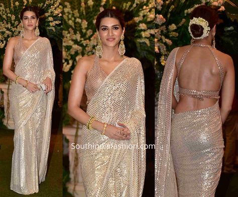 Kriti Sanon attended Ambani's Ganesh puja celebrations wearing an ivory badla work saree paired with matching backless halter neck blouse by Manish Malhotra. Ganesh Puja Outfit, Badla Work, Manish Malhotra Saree, Ganesh Pooja, Kerala Saree Blouse Designs, Ganesh Puja, Indian Sari Dress, Sari Blouse Designs, Indian Saree Blouses Designs