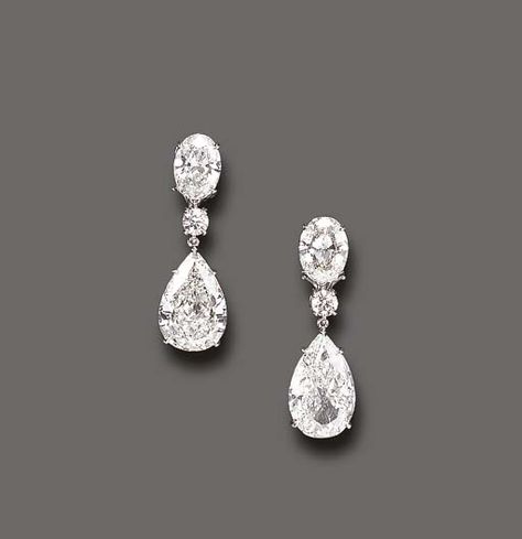 AN ELEGANT PAIR OF DIAMOND EAR PENDANTS  Each pear-shaped diamond, weighing approximately 5.07 or 5.51 carats, suspended by a circular-cut diamond spacer, to the oval-cut diamond surmount, weighing approximately 1.80 or 1.87 carats, mounted in platinum Luxury Earrings Diamond, Teardrop Diamond Earrings, Wedding Diamond Drop Earrings, Diamond Brilliant Cut Drop Earrings, Luxury Diamond Earrings, Tiffany Diamond Earrings, Big Diamond Earrings, Bridal Diamond Earrings, Oval Diamond Earrings