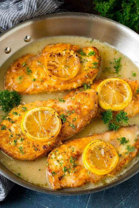 Chicken francese in a white wine sauce, garnished with lemon slices. Chicken Francaise Recipe, Chicken Francese Recipe, Chicken Francaise, Ina Garten Chicken, Chicken Francese, Lunch Restaurant, Traditional Italian Dishes, Ina Garten Recipes, Clam Recipes