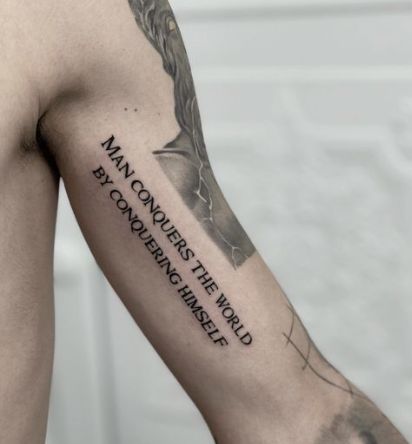 The Man Conquers Tattoo Quotes For Guys Tattoo Ideas For Men Arm Meaningful, Tattoo Designs Men Quote, Quotes For Tattoos For Guys, Tattoo Ideas Men Meaningful Arm Sleeve, Mens Quote Tattoos, Meaningful Tattoo Quotes For Men, Quotes Deep Meaningful Tattoo, Writing Tattoos For Men, Quote Tattoo Men