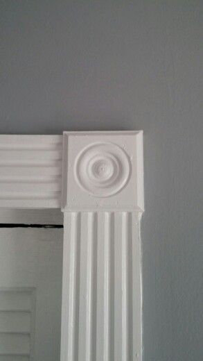 beautiful rosettes and wood trim framing every window and door Window Trim With Rosettes, Victorian Architrave Door Frames, Victorian Trim Moldings, Framed Archway, Rosette Molding, Rosette Window, Window Framing, Rosette Trim, Wood Door Frame