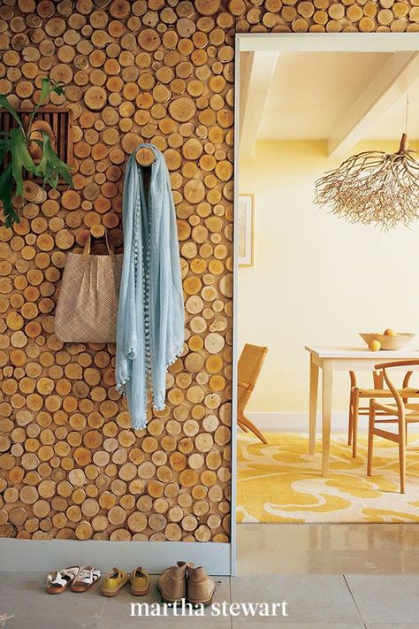 If you have a surplus of reclaimed wood, turn the bundle into a statement wall for your home. Pictured here, birch poles sliced into disks and glued to plywood panels create a graphic wall mosaic. Strategically placed longer pieces are used as hooks for bags and artwork. #marthastewart #diydecor #diyprojects #diyideas #hobby Reclaimed Wood Accent Wall, Wallpaper Minimal, Diy Wood Wall, Log Wall, Diy Rustic Home, Wooden Log, Wood Accent Wall, Wood Logs, Diy Holz