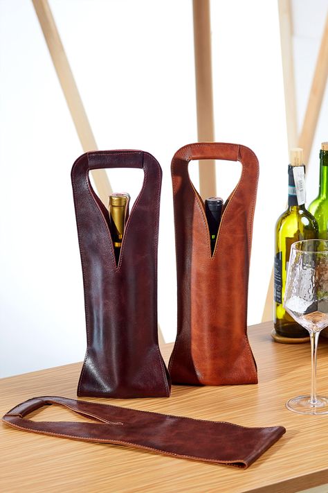 "A bag for one bottle is made from quality and nice to touch leather. Carefully sewn from one single piece of leather. This adds uniqueness and exquisite shape. Suitable for most bottles of different sizes - for sparkling wine, and for unusual-shaped, exotic drinks as well. But for standard bottles of wine it fits perfectly. We have strengthened the handle with additional layers of leather to feel confident when carrying it. Also this will allow to keep the shape of the bag with a smooth waist a Slim Aesthetic, Leather Wine Tote, Leather Wine Carrier, Crea Cuir, Diy En Cuir, Wine Caddy, Wine Bottle Bag, Whiskey Gifts, Bottle Carrier