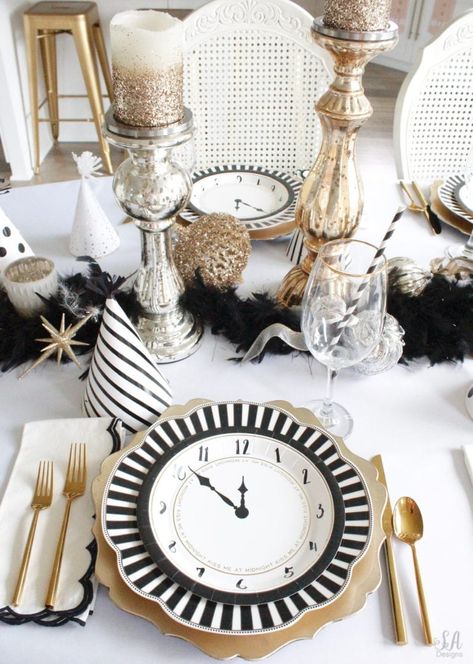 black white gold tablescape, black and white striped graces dinner plates, gold chargers, crystal chandelier, clock plates new years eve, new years eve game, new years eve food, mercury glass candlesticks, sugar paper la white black scalloped dinner napkins, party hat, mercury glass candlesticks, glitter candles New Year’s Eve Place Setting, New Years Place Setting, New Years Table Centerpieces, New Years Brunch Decorations, New Years Dinner Party Table Settings, New Year’s Eve Tablescape, New Year’s Eve Table Setting, New Years Centerpiece Ideas, New Year Dinner Table Decoration