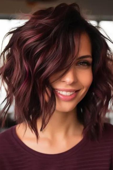 Choose deep burgundy shag with a wavy texture for a classy, rich look. The shag hairstyle is of medium length, deep burgundy in color and wavy for a natural look and professionalism. Click here to check out more trending medium-length shag haircut ideas. Ash Brown Short Hair Balayage, Dark Red Lob Haircut, Highlights For Red Brown Hair, Mid Length Angled Haircut, Deep Red Bob Hair, Medium Length Haircut Beach Waves, Highlight For Graying Hair, Cute Short Fall Hairstyles, Best Colors For Short Hair