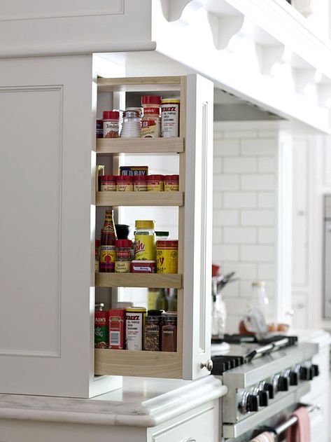 Pullouts to the side of the cooktop provide storage for spices and cooking oils. Organizar Closet, Cocina Diy, Driven By Decor, Kitchen Storage Ideas, Kabinet Dapur, Small Kitchen Storage, Kitchen Hacks Organization, Spice Storage, Kitchen Cabinet Storage