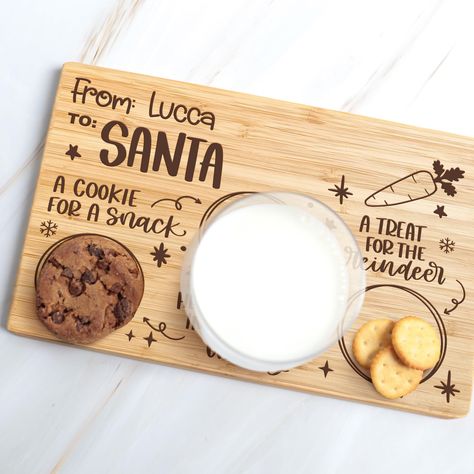 PRICES MAY VARY. MATERIAL: This serving board is made with bamboo. It is lightweight which is perfect for kids to carry it themselves and be more involved in this Christmas Eve tradition and also they will be a great addition to your holiday pictures. CUSTOMIZATION: We improved our personalization and is now done with permanent UV printing that is made directly in the tray so no sticker is used which means it won't fade off or peel off ensuring a long lasting durability. It's important that you Santa Milk And Cookie Tray, Cookies For Santa Tray, Milk And Cookies For Santa, Santa Tray, Laser Crafts, Personalized Tray, Santa Mini, Cookies For Santa Plate, Christmas Eve Traditions