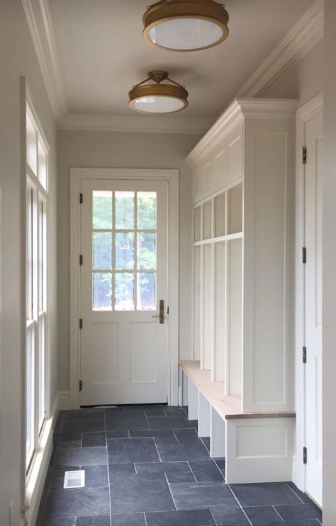 Mudroom Ceiling Lights, Bluestone Mudroom, Mudroom Entry Door, Mudroom With Vaulted Ceiling, Mud Room Door Exterior, Mudroom Laundry Room Lighting, Mudroom With Bathroom Layout, Laundry Room With Tall Ceilings, Mud Room Exterior Door