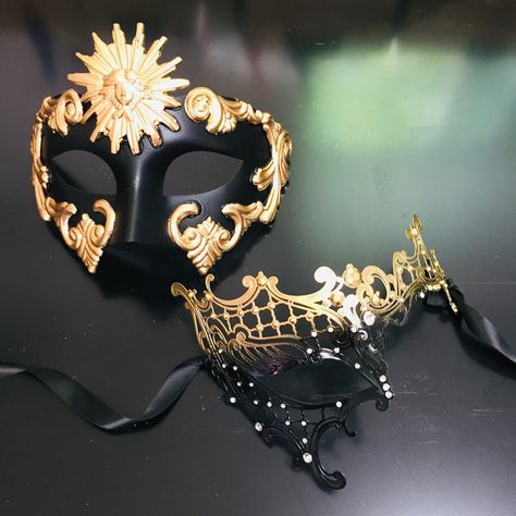 The Sun God & Phantom Couples Mask Set features a stunning pair of masks designed for those who seek luxury and sophistication. The set includes a black mask with bold golden embellishments, representing strength and power, and a delicate black and gold filigree mask adorned with crystals for an elegant and mysterious look. Perfect for masquerade balls, themed events, or formal galas, this set promises to make a statement.  Size/Type: One size fits most Mask Colors: Gold and Black Mask Material: High-quality resin and metal filigree Accent Material: Gold metallic paint and crystal accents Age Group/Gender: Adult, Couples  SEO URL Handle: masquerade-mask-sun-god-phantom-gold-black-couples SEO Savvy Product Name: Sun God & Phantom Couples Masquerade Masks SEO Image Name: masquerade-mask-sun- Moon Masquerade Mask, Masquerade Ball Gowns Elegant With Mask, Black And Gold Mask, Phantom Mask, Couples Masquerade Masks, Masquerade Ball Gowns, Mask Designs, Gold Mask, Masquerade Masks