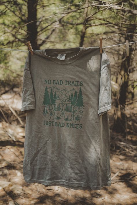 No Bad Trails, Just Bad Knees graphic t-shirt. Each t-shirt is pressed house on a comfort colors unisex shirt. T-shirts are made of a soft cotton blend and features a vibrant direct to fabric transfer design that won't fade or crack. COLOR PICTURED: KHAKI Shop our wanderlust inspired t-shirt collection. Perfect for those who enjoy hiking, camping, exploring the outdoors and all adventure seeking enthusiasts. keywords: wanderlust t-shirt, adventure t-shirts, graphic tees, unisex outdoorsy shirts, Outdoorsy Aesthetic, Outdoorsy Shirt, Hiking Apparel, Reuse Clothes, Travel Apparel, Bad Knees, Outdoor Aesthetic, Projets Cricut, Trendy Shirt Designs