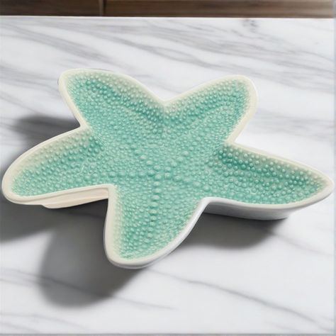 Discover the charm of this ceramic starfish serving platter! Its teal green color and mottled texture embody the essence of a starfish. Perfect for your dining table or as a delightful home accent. Safe to use in the dishwasher and microwave. Dimensions: 11.5" diameter x 1.5" deep Starfish Ceramics, Ceramic Starfish, Microwave Dimensions, Starfish Jewelry, Tropical Food, Teal Green Color, Hand Building, Tropical Party, Serving Plate