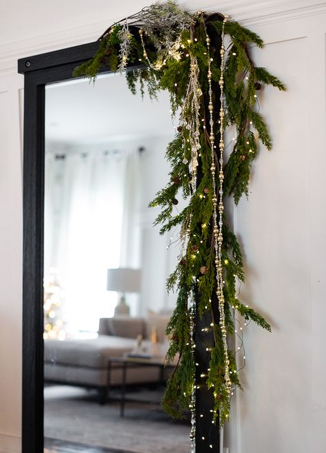 Craftberry Bush | Cozy Christmas Tour Part 2 | https://www.craftberrybush.com White Brick House Christmas Decor, Christmas Garland Ideas Hallway, Garland Inspo Christmas, Garland Christmas Ideas, Bows On Sconces For Christmas, How To Hang Candles From Ceiling, Hanging Light Christmas Decor, No Mantel Christmas Decor, Christmas Trellis Outdoor