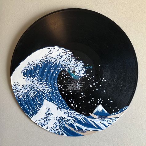 "This painting displays a rendition of \"The Great Wave off Kanagawa.\" Please keep in mind that any reproduced painting will be slightly different.  Add a hanging wall frame to complete your purchase!  *FRAMES ONLY FOR 12 INCH RECORDS It was hand painted with acrylic paint. Pictured item is 12x12 inches - Use as decorative wall art - Perfect to spice up any room - Gift idea for friends/family/significant other - Colors used: shades of blue, white, and tan" Painting A Record, Records Artwork, Record Painting Ideas, Record Decor, Vinyl Painting, Vinyl Paintings, Painted Vinyl Records, Record Painting, College Room Decor