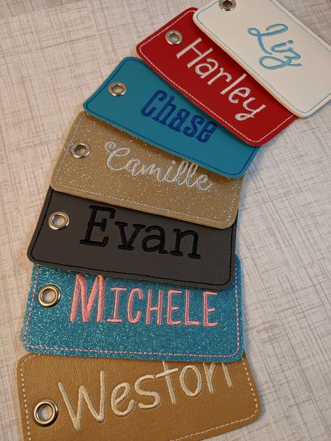 "Personalize your own luggage tag! Can also be used for backpacks, laptop bags, gym bags, or diaper bags. Makes a great personalized wedding, graduation, or birthday gift as well. This luggage tag is made with vinyl which is durable and easy to clean. The tag measures approx. 2.5\" tall by 4.5\" wide. The back vinyl and thread matches the front giving them a very professional, finished look. The tags are attached with a high quality, flexible, clear plastic 6\" luggage loop. These are completely Embroidered Luggage Tags, Luggage Tag Designs, Personalized Bag Tags, Name Embroidery, Travel Luggage Tag, Backpack Tags, Embroidered Name, Sewing Embroidery, Cork Fabric