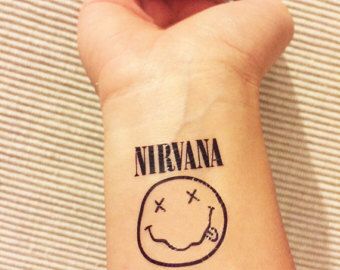 Nirvana smiley tattoo Nirvana Logo Tattoo, Nirvana Tattoo Lyrics, Music Sleeve, Nirvana Tattoo, Stick Tattoo, Rock Tattoo, Knuckle Tattoos, Lyric Tattoos, Retro Tattoos