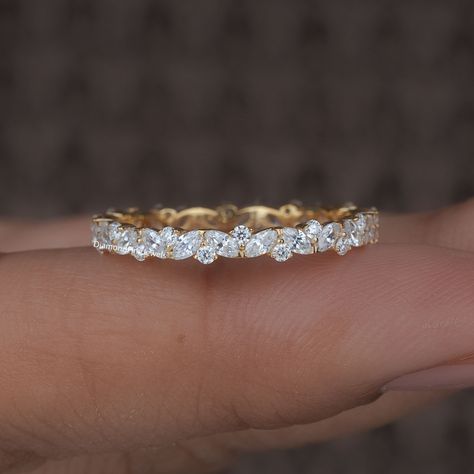 Delicate Marquise and Round Moissanite / Lab Grown Diamond Wedding Band, 14K Gold Full Eternity Band, Diamond Stacking Ring Anniversary Band ● 𝐃𝐢𝐚𝐦𝐨𝐧𝐝 𝐃𝐞𝐭𝐚𝐢𝐥𝐬: ➢ Shape: Marquise Cut and Round Cut ➢ Diamond Type: Lab Grown Diamond ( EF - VS) / Moissanite ( DE - VVS) ➢ Carat:  0.8 TCW apx 𝐑𝐢𝐧𝐠 𝐃𝐞𝐭𝐚𝐢𝐥𝐬: ➢ Shank Width : 2.3 MM ➢ Shank Thickness : 1.8 MM 𝐀𝐥𝐥 𝐥𝐢𝐬𝐭𝐞𝐝 𝐫𝐢𝐧𝐠 𝐚𝐫𝐞 𝐦𝐚𝐝𝐞 𝐚𝐬 𝐚 𝐜𝐮𝐬𝐭𝐨𝐦 𝐨𝐫𝐝𝐞𝐫, 𝐚𝐧𝐝 𝐡𝐞𝐧𝐜𝐞, 𝐭𝐡𝐞 𝐦𝐞𝐚𝐬𝐮𝐫𝐞𝐦𝐞𝐧𝐭𝐬 𝐨𝐫 𝐜𝐚𝐫𝐚𝐭 𝐰𝐞𝐢𝐠𝐡𝐭 𝐜𝐚𝐧 𝐝𝐢𝐟𝐟𝐞𝐫 𝐬𝐥𝐢𝐠𝐡𝐭𝐥𝐲 𝐝𝐞𝐩𝐞𝐧𝐝𝐢𝐧𝐠 𝐨𝐧 𝐭𝐡𝐞 𝐚𝐯𝐚𝐢𝐥𝐚𝐛𝐢𝐥𝐢𝐭𝐲 𝐨𝐟 𝐝𝐢𝐚𝐦𝐨𝐧𝐝𝐬. 𝐅𝐨𝐫 𝐦𝐨𝐫𝐞 𝐝𝐞𝐭𝐚𝐢𝐥𝐬, 𝐟𝐞𝐞𝐥 𝐟𝐫𝐞𝐞 𝐭𝐨 𝐜𝐨𝐧𝐭𝐚𝐜𝐭 𝐮𝐬. ● 𝐂𝐞𝐫𝐭𝐢𝐟𝐢𝐜𝐚𝐭𝐢𝐨𝐧 We do provide Jewelry Certificate on request Eternity Ring Diamond Marquise, 7 Diamond Wedding Band, Mixed Metal Wedding Bands, Mixed Stone Wedding Band, Eternity Ring Diamond Stack, Eternity Ring Stack, Marquise Eternity Band, Pave Wedding Bands, Stacked Rings