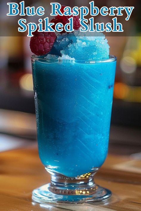 Blue Raspberry Spiked Slush is a refreshing and vibrant cocktail perfect for cooling down on a hot day. This icy drink combines raspberry vodka, blue curaçao, lemon juice, and simple syrup, blended with ice to create a frosty treat that’s as visually appealing as it is delicious. Raspberry Drink Recipes, Raspberry Vodka Drinks, Alcoholic Slush Recipes, Alcoholic Slush, Blue Curacao Drinks, Vodka Blue, Raspberry Drink, Slushy Drinks, Slush Recipes