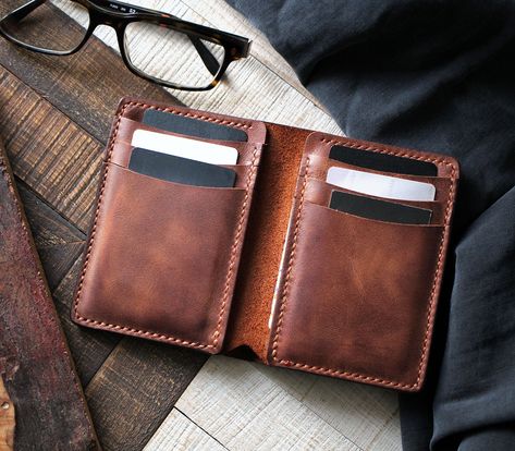 We added an extra cash pocket outside of the vertical wallet and here come the Laodikya XL!  The attention to detail and minimalist design of the Laodikya XL wallet will elevate your everyday style and turn heads everywhere you go. Every hide is unique and carries its character. Because of the nature of leather, there may be several blemishes on the leather, as seen in the photos. Custom Leather Wallet, Cash Holder, Diy Leather Bracelet, Cash Wallet, Leather Billfold, Handmade Leather Wallet, Leather Bifold Wallet, Wallet Organization, Leather Wallet Mens