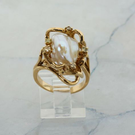 14K Yellow Gold Pearl and Diamond Ring, interesting asymmetrical design, Ring size 6.5, 8.7 grams Stock # R00070 This listing contains photographs of the actual item you will receive.  Our items are in excellent condition with little or no signs of wear and many are one of a kind pre-owned estate finds.   Please look closely at the pictures in this listing as they are part of the product description. Please read the description, as any imperfections or condition comments will be included.  We do our best to accurately describe the condition of each piece and encourage you to ask questions prior to purchase.    We are happy to address any questions you may have.  Please contact us.  Our Store has many other items for sale.  We specialize in fine & designer jewelry, watches & more.    Coloni Pearl And Gold Jewelry Aesthetic, Inlaid Engagement Rings, Vintage Italian Engagement Rings, Antique Engagement Rings Vintage 1920s Gold, Art Nouveau Engagement Ring Antique, Gold Pearl Wedding Ring, Gold Engagement Ring With Silver Band, Pearl And Gold Engagement Ring, Evorden Rings