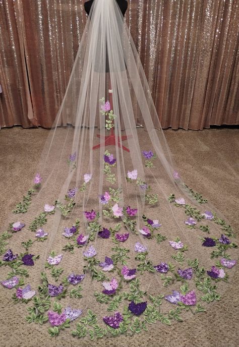 The Lilac Veil is a 10-foot cathedral, made with ivory tulle, green vines, and purple Lilacs embroidered in many shades. Lilacs are all embroidered with a custom blend of thread colors to look as real as possible. The colors are fully customizable to your wedding palette, and I love custom orders so please reach out with any questions! Lilac And Wisteria Wedding, Wedding Ideas Light Purple, Purple Gray And White Wedding, Wedding Light Purple Theme, Subtle Rapunzel Wedding, Purple And Silver Wedding Flowers, Pink Purple And Sage Wedding, White Lilac Bouquet Wedding, Black Gold Lavender Wedding