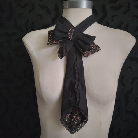 An elegant yet stylish necktie for any outfit, slanted bow with bat cutout on tie.  Made of antique cotton Sateen scraps, antique edging cotton lace, vintage cotton, scrap rayon rosette trim, and antique jet bead and vintage metal snaps. Made using a self drafted pattern. Measurements- Width at widest point: 7 Inches Neck Width: 13.5 Inches max (snaps can be moved to accommodate larger neck size) Length: 18.5 Inches  Total Length: 31 Inches ++Important: Store Return Policy++ *PLEASE CONSIDER PURCHASING THROUGH MY MAIN SHOP & NOT ETSY.* TheWidowsHouse does not accept any returns at this time, nor any refunds once the item is shipped. I will allow cancellations under some circumstances, but they must be requested/ issued immediately. Once the item is packaged and shipped cancellations/refund Bow Tie Outfit, Rosette Trim, Necktie Pattern, Tie Around Neck, Etiquette And Manners, Neck Accessories, Lace Vintage, Dress Design Sketches, Kawaii Accessories