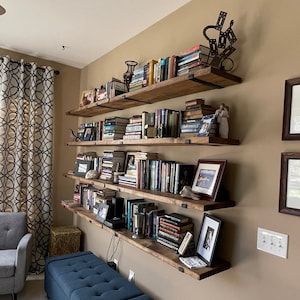 J Bracket Shelves, Office With Open Shelving, Floating Shelf Library Wall, Diy Bookshelves Ideas Living Room, Wall Shelf Library, Books Behind Sofa, Floating Shelves The Home Depot, Wood Floating Bookshelves, Open Shelf Bookshelf