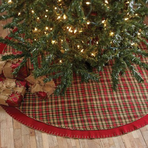 Claren Tree Skirt 48" Tree skirts add a touch of style beneath your tree when you decorate for the holidays. This Claren Tree skirt is perfect for bringing a woodsy, country look to your room when you use it to complete your Christmas Tree.. It measures 48" in diameter. The front displays a cherry red, forest green, and khaki plaid woven fabric with detailed stitching. There is a 2" cherry red felt border that also displays detailed stitching to complete the simple charm of this accent. There ar