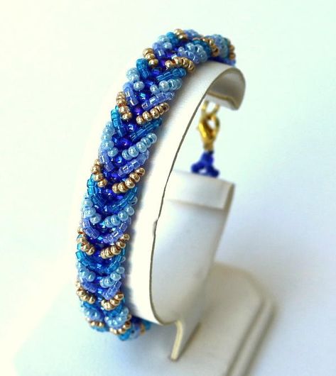 This stunning Chevron Seed Bead Bracelet Pattern is truly a DIY bracelet that will have all of your friends jealous of your amazing beading skills. Plus, the gorgeous dark and light blue hues in this beaded bracelet are perfect for dressing up your outfits this winter season. The chevron pattern for this handmade bracelet keeps you looking fresh and chic and most definitely gorgeous. You will transform into a stunning ice queen and, you could perhaps even turn into your own Elsa with this whimsi Seed Bead Bracelet Pattern, Bracelet Embroidery, Necklace Embroidery, Seed Bead Bracelet Patterns, Seed Bead Tutorials, Embroidery Bracelets, Bracelets Ideas, Bead Tutorials, Seed Bead Patterns