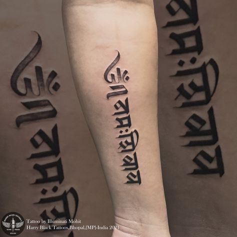 The shape of om has the face of a smiling Shiva that makes it a modern Indian design. This tattoo symbolizes peace and prosperity Omm namaha shivaya tattoo by - @illuminatimohit Only at Harry black tattoos dB city mall bhopal For consultation and appointment 07552514759/9981271965 #illuminatimohit #tattoolife #tattoobyilluminatimohit #ommnamahshivaya #tattoo Ohm Namashivaya Tattoo, Smiling Shiva, Om Namah Shivay Tattoo, Om Namah Shivaya Tattoo, Sanskrit Calligraphy, 19 Tattoo, Hanuman Tattoo, Harry Tattoos, Mahadev Tattoo