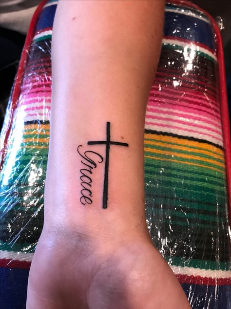 Cross Name Tattoos For Women, Cross With Name Tattoo, Cross Name Tattoo, Grace Cross Tattoo, Grace Tattoos For Women, Girl Cross Tattoos, Wedding Date Tattoos, Feminine Cross Tattoo, Wrist Tatoo