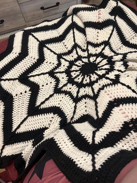 This blanket acrylic is made by me into a twelve point star that is webbed to look like a cob web blanket. It is a great size. It's very soft and warm. Cozy to cuddle up in. Celestial Granny Square Blanket, Crochet Spiderweb Blanket, Spider Web Crochet Blanket, Crochet Blanket Halloween, Gothic Crochet Blanket, Goth Crochet Blanket, Spooky Crochet Pattern, Skull Crochet Blanket, Halloween Blanket Crochet