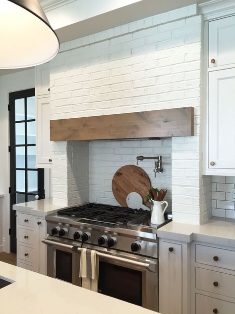 Brick surrounding stove #modernfarmhouseproject House of Jade Interiors Alcove Stove Kitchen, Brick Vent Hood Kitchen, Brick Range Hood Surround, Brick Behind Stove In Kitchen, Stove Brick Surround, Brick Stove Surround Kitchen, Arch Over Stove, Brick Range Hood, Stove Cove