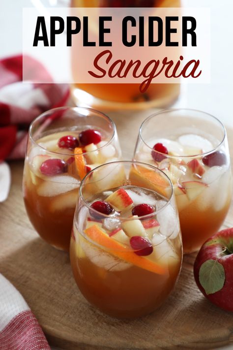 This Apple Cider Sangria is everyone’s favorite Fall cocktail! The perfect sangria for a fall celebration. The combination of white wine, apple cider, salted caramel vodka, cinnamon and fresh seasonal fruit will get you in the mood for Fall. #FallCocktail #Sangria #AppleCiderSangria #Thanksgiving #AppleCocktail Apple Cider Autumn Sangria, Fall Spiced Apple Cider Sangria, Apple Cider Caramel Vodka White Wine, Apple Cider Sangria Recipe With Vodka, Cider Alcohol Drinks Fall, Fall Cider Cocktails, Apple Cider Wine Slushies, Thanksgiving Apple Cocktails, Fall Sangria Recipes White Apple Cider