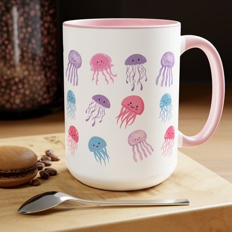 This mug is not just a mug for your favorite beverages; it's a work of art featuring adorable jellyfish design that adds a splash of playfulness to your coffee routine.   Not just for beverages, this versatile mug can also serve as a cute desk accessory, pen holder, or a planter for small succulents. It's perfect for adding a touch of fun to your home or office. .: Material: 100% ceramic .: One size: 15oz (0.44 l) .: Lead and BPA-free .: Glossy finish .: Interior and handle available in 5 colors Paint On Mugs Diy, Diy Mug Painting Ideas, Ceramic Mugs Painting, Paint A Pot Ideas Mug, Jellyfish Mug, Painting Mugs Ideas Easy, Ceramic Coaster Painting Ideas, Mug Ceramic Painting, Paint Your Own Mug Ideas