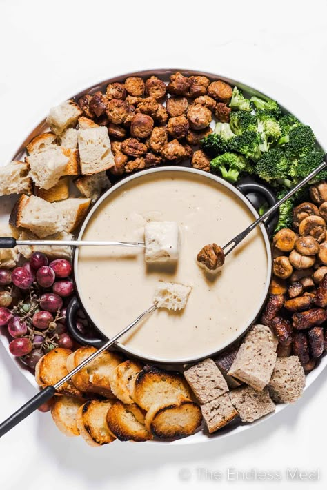 This cheese fondue is creamy, smooth, and by far the best! It's classic melted gruyère cheese flavored with caramelized shallots, apple brandy, and warm spices. It's an easy recipe that's perfect for seasonal gatherings, and it's ready in just 35 minutes! #theendlessmeal #fondue #cheesefondue #gruyerefondue #cheese #gruyere #gruyerecheesefondue #dinner #appetizer Mini Fondue Ideas, Cheese Fondue Board, Vegetarian Fondue, Fondue Charcuterie Board, Fall Fondue, Fondue Party Ideas, Christmas Fondue, Fondue Board, Fondue Bar