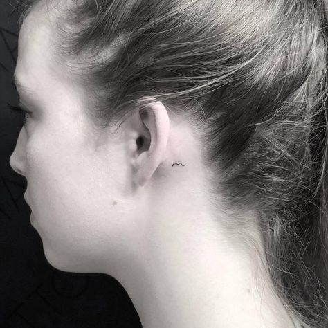 Tiny “m” letter tattoo behind the left ear. Behind The Ear Tattoo Ideas Letter, Tiny M Tattoo, Small M Tattoo Letter, Letter M Tattoo Ideas, Letter M Tattoos, Behind Ear Tattoo Small, Sister Tats, Tattoo Letters, Letter Tattoos