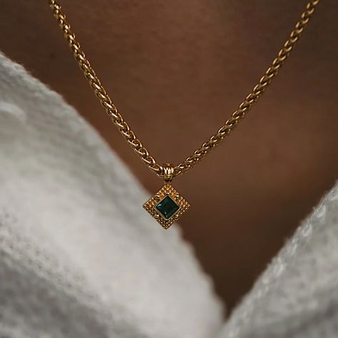 The 'Shiloh' Necklace is a timeless beauty that seamlessly blends vintage charm with contemporary elegance. Adorned with a cubic zirconia emerald stone, this necklace exudes a captivating green brilliance that catches the eye. The vintage textured edges add a touch of nostalgia, infusing the piece with character and depth. All of our 18k gold or silver plated jewellery should be stored in a cool, dry place and cleaned carefully with a soft non-abrasive cloth to maintain shine.  Our pieces also c Necklaces Green Stone, Gold Necklace Green Stone, Gold And Emerald Necklace, Jewelry Capsule, Green And Gold Necklace, Prom Jewellery, Green Stone Necklace, Delicate Gold Necklace, Sparkly Things