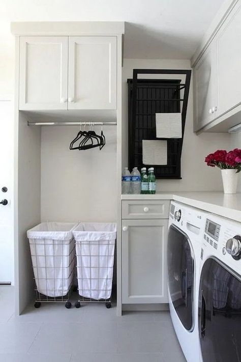 small corner laundry station with grey shaker cabinets, a wall mounted drying rack, rolling laundry bins, clothes rack and lots of counter space Diy Lavanderia, Diy Laundry Room Storage, Elegant Laundry Room, Landry Room, Laundry Room Storage Shelves, Small Laundry Room Organization, Drying Room, Tiny Laundry Rooms, Room Storage Diy