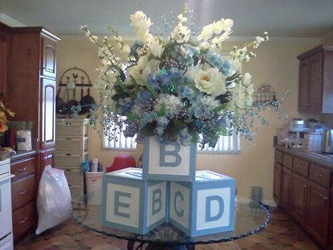 Baby boy shower centerpiece for buffet table. I bought 3 wood block boxes at hobby lobby and painted them. Added foam to one and made the flower arrangement. The blocks were 12 x 12 . The final arrangement was very large and perfect for a baby shower buffet. Baby Boy Flower Arrangements, Baby Shower Flower Arrangements, Baby Shower Buffet, Oblong Table, Diy Baby Shower Centerpieces, Baby Shower Checklist, Mesas Para Baby Shower, Boy Baby Shower Centerpieces, Boy Baby Shower Ideas