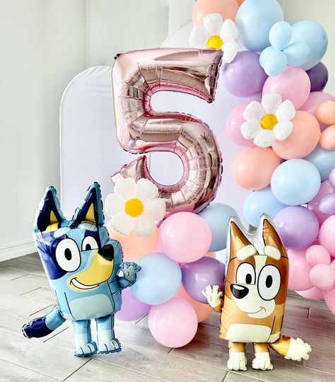 Welcome to Sweet Escapes By Debbie  Make your Bluey-themed party extra special with our Bluey and Bingo Balloon Garland! This colorful and fun balloon garland is the perfect addition to any celebration, bringing the beloved characters Bluey and Bingo to life.  Balloon towers are the perfect way to add that wow to your party. With helium prices increasing and sometimes hard to find this is the perfect balloon option filled with air! This kit includes everything you need to create your tower. This is a great accent or stunning centerpiece for your party. It is also great as a photo prop! Included in each DIY kit: Colors pink, matte blue, melon and blossom ~ 12 11" latex balloons ~ 3 balloon clips ~ One pink number ~ One 12" mylar daisy ~ Glue dots ~ Add on Bluey, Bingo or both! ~ (1) Dual ac Diy Bluey Centerpieces, Bluey Birthday Party Balloons, Bluey Birthday Party Girly, Blue And Pink Balloon Garland, Bingo Birthday Party Theme, Bluey Birthday Party Ideas Pink, Diy Bluey Birthday Decorations, Bluey Centerpiece Ideas, Bluey Diy Party