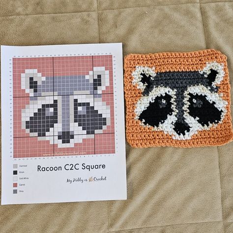 This Raccoon Single crochet graph square was adapted from "My Hobby is Crochet" C2C pattern online. 26 Rows with no trim (if counting the first single stitch chain as a row). H-5mm Hook. Red Heart Super Saver Colors used Black, Charcoal, Carrot, & Oatmeal. Cream (dollar tree). Raccoon Granny Square, Diy Crochet Squares, Crochet Raccoon Applique, Crochet Grid Patterns Halloween, Crochet Raccoon Free Pattern, Small Tapestry Crochet Pattern, Raccoon Pixel Art, Pixel Crochet Pattern, Raccoon Blanket