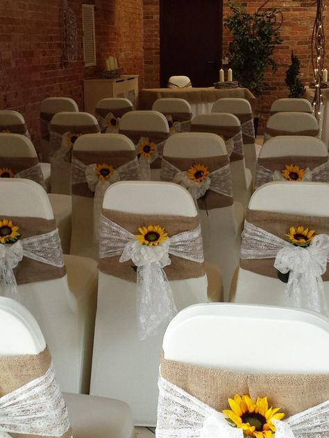 Beautiful hessian and lace chair sashes with bright sunflowers. www.elshamhallevents.co.uk Quince Sunflower Theme, Rustic Wedding Decor Sunflowers, Sunflower Themed Quinceanera, Sunflower Quince Theme, Quinceanera Sunflower Theme, Wedding Decorations Sunflowers, Wedding Sunflower Decorations, Yellow Quinceanera Theme Decorations, Sunflower Quinceanera Theme